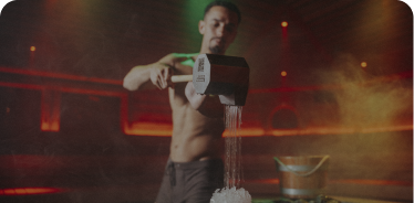 Shirtless man heating sauna
