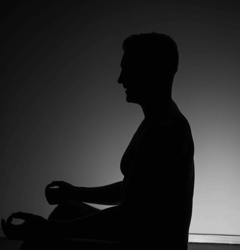 silhouette of a man meditating